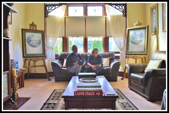 Paul Wilson, Sue Glaisher and Archie the Cairn terrier at home in the 'Grande Salon'.